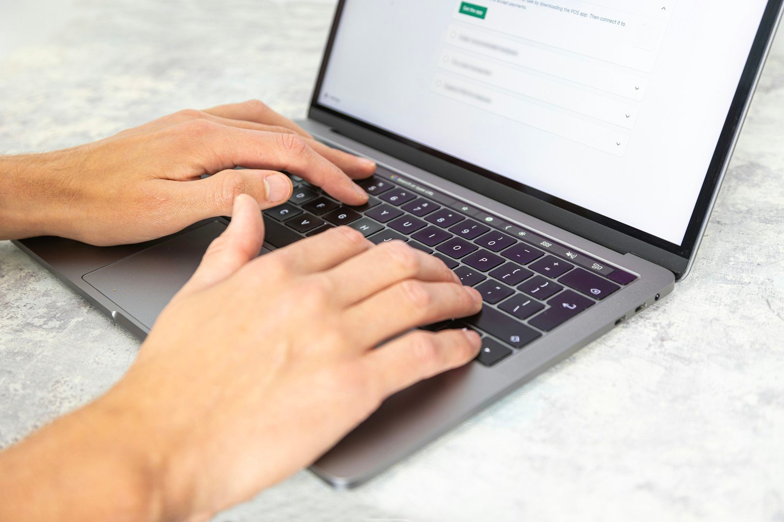 Hands typing SEO content on a laptop keyboard